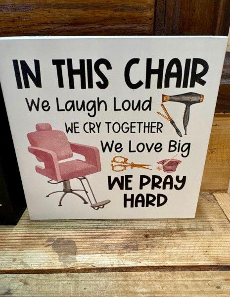 Sign reading In this chair we laugh loud, cry together, love big, pray hard